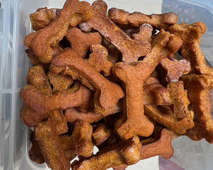 A pile of honey bones, dog treats made with pumpkin, peanut butter, and honey.